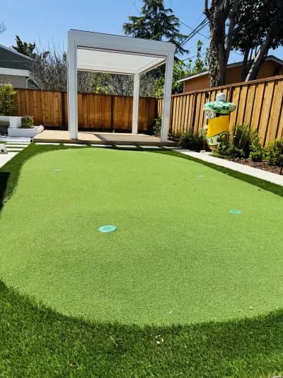 Artificial turf putting green with practice cups set into the lawn