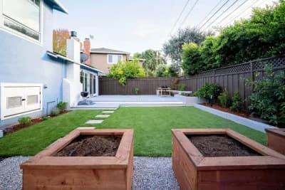 Side yard with artificial turf, redwood raised planters and a paver walkway
